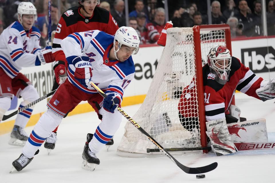 New York Rangers' Filip Chytil, left, shoots on New Jersey Devils goaltender Vitek Vanecek during the first period of Game 2 of an NHL hockey Stanley Cup first-round playoff series in Newark, N.J., Thursday, April 20, 2023.