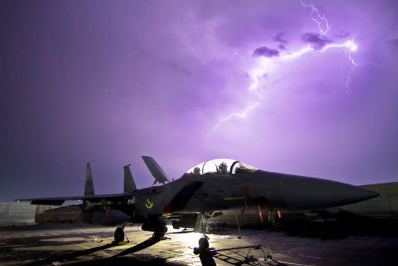 An F-15E Strike Eagle is one of many aircraft possibly affected by counterfeit Chinese parts. Here one jet is illuminated by a lightning storm Oct. 6, 2011, at Bagram Air Field, Afghanistan.