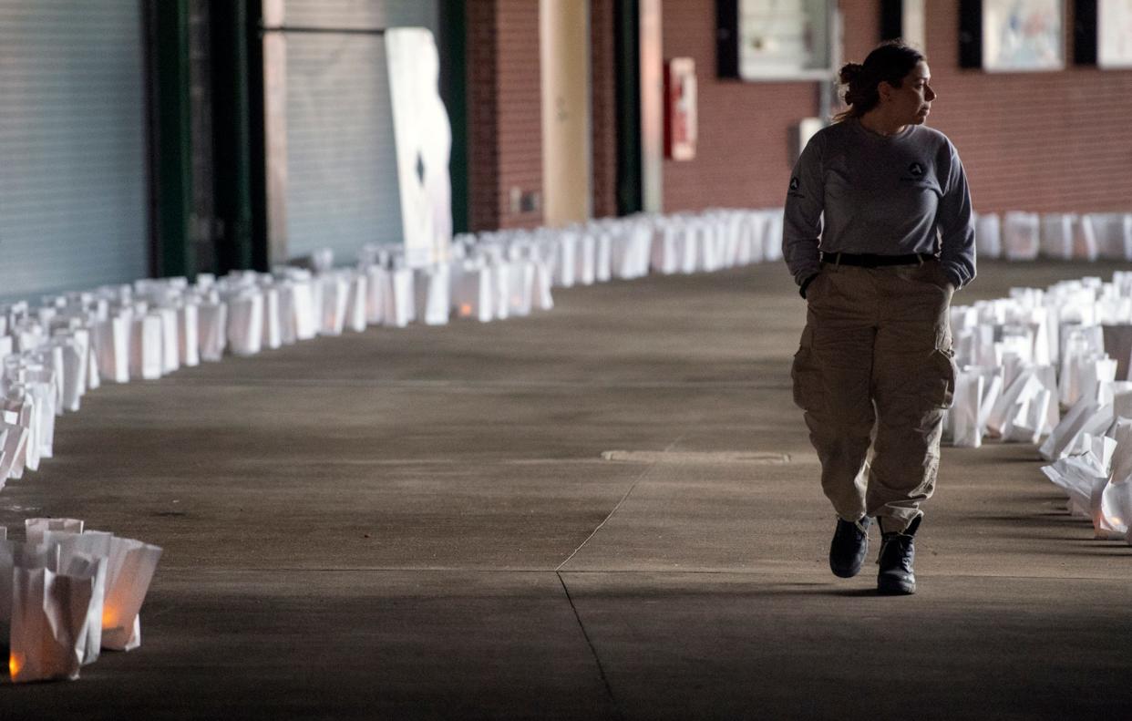 Alyssa De Las Salas walks through a sea of 1,488 luminaries last month during A Time of Remembrance & Light: A COVID-19 Memorial Event at PeoplesBank Park in York, Pennsylvania.