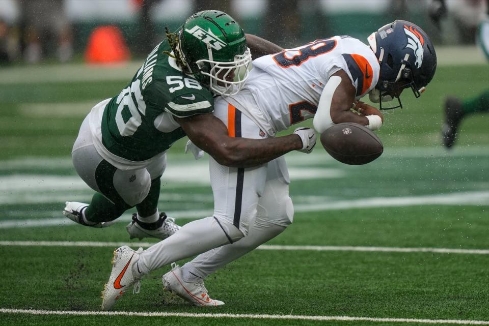 Badie (right) caught a pass on a third down play just before the end of the first quarter and was immediately hit by the Jets' Quincy Williams (left) (AP)