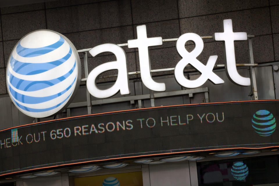 FILE - In this Oct. 24, 2016, file photo, the AT&T logo is positioned above one of its retail stores in New York. AT&T has drawn ridicule by relabeling the network used by some of its phones as “5G E” to signal that the next-generation wireless network is here. Problem is, phones capable of connecting to 5G aren’t coming for another few months, and a national 5G network won’t be deployed until 2020 or 2021. (AP Photo/Mark Lennihan, File)