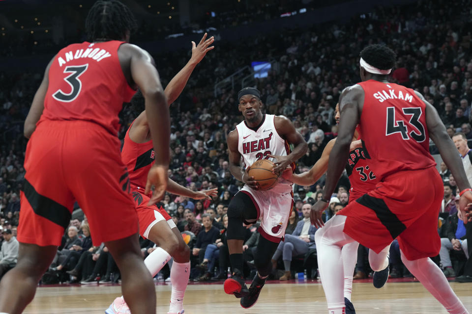 Miami Heat's Jimmy Butler drives at the Toronto Raptors defense during the second half of an NBA basketball game, Wednesday, Dec. 6, 2023 in Toronto. (Chris Young/The Canadian Press via AP)