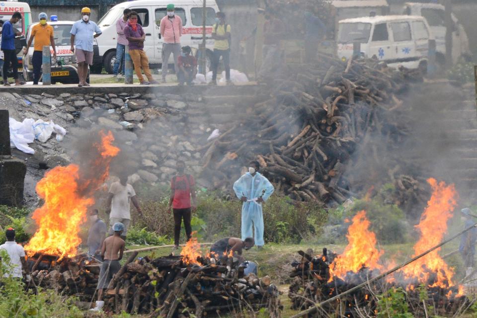 People watch the cremation of people who died due to the COVID-19 at Sahudangi Crematorium, about 9 miles from Siliguri, India, on May 4, 2021. / Credit: DIPTENDU DUTTA/AFP/Getty