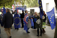 Anti-Brexit remain in the European Union supporters protest across the street from the Houses of Parliament in London, Tuesday, Oct. 15, 2019. A Brexit divorce deal is still possible ahead of Thursday's European Union summit but the British government needs to move ahead with more compromises to seal an agreement in the next few hours, the bloc said Tuesday. (AP Photo/Matt Dunham)