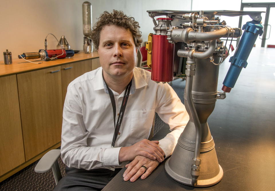 Rocket Lab CEO Peter Beck sits alongside a Rutherford rocket engine in Auckland, October 20 2015.  The next revolution in space, making humdrum what was long the special preserve of tax-funded giants like NASA, will be launching next year from a paddock in New Zealand's remote South Island. Picture taken October 20, 2015.  REUTERS/Nigel Marple  TPX IMAGES OF THE DAY