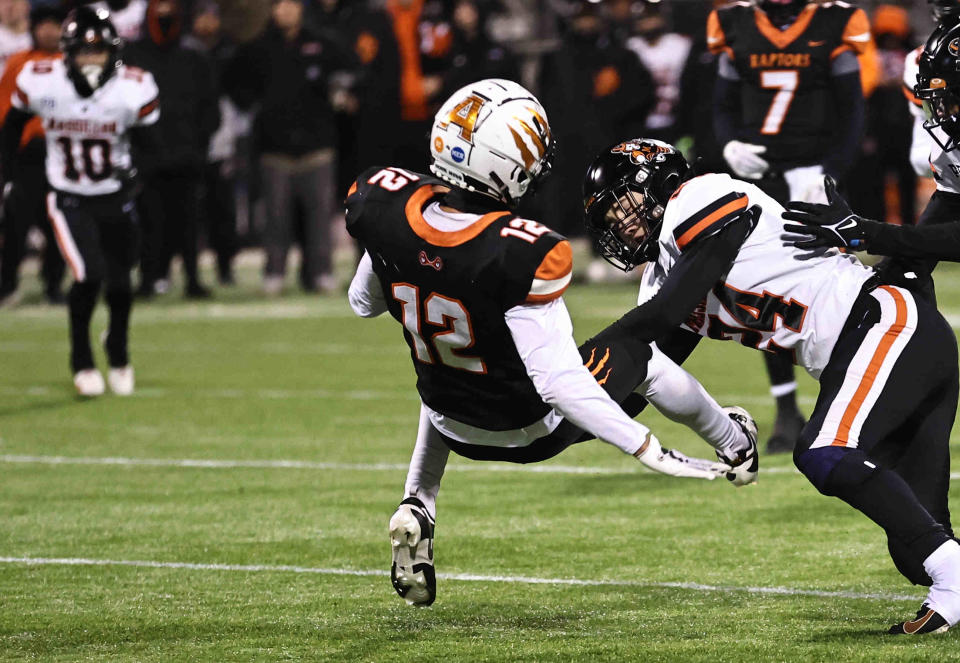 Massillon safety Tyler Hackenbracht (24) hits Anderson wide receiver Trace Jallick on Friday.