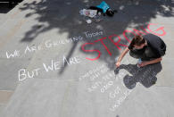 <p>A man writes a message on the pavement in central Manchester, Britain on May 23, 2017. (Darren Staples/Reuters) </p>