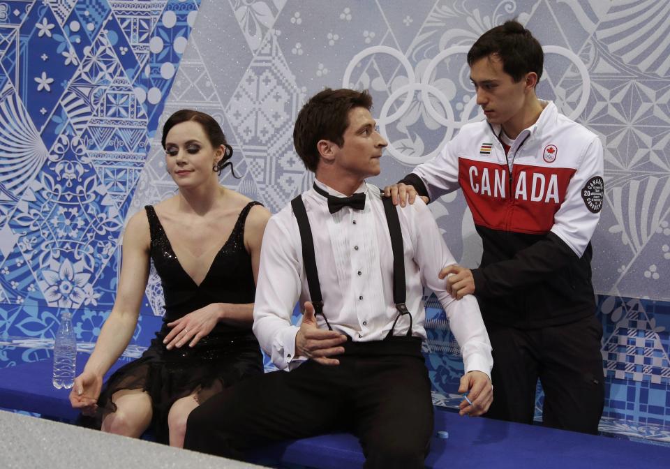 Tessa Virtue and Scott Moir of Canada react with teammate Patrick Chan during the Team Ice Dance Short Dance at the Sochi 2014 Winter Olympics