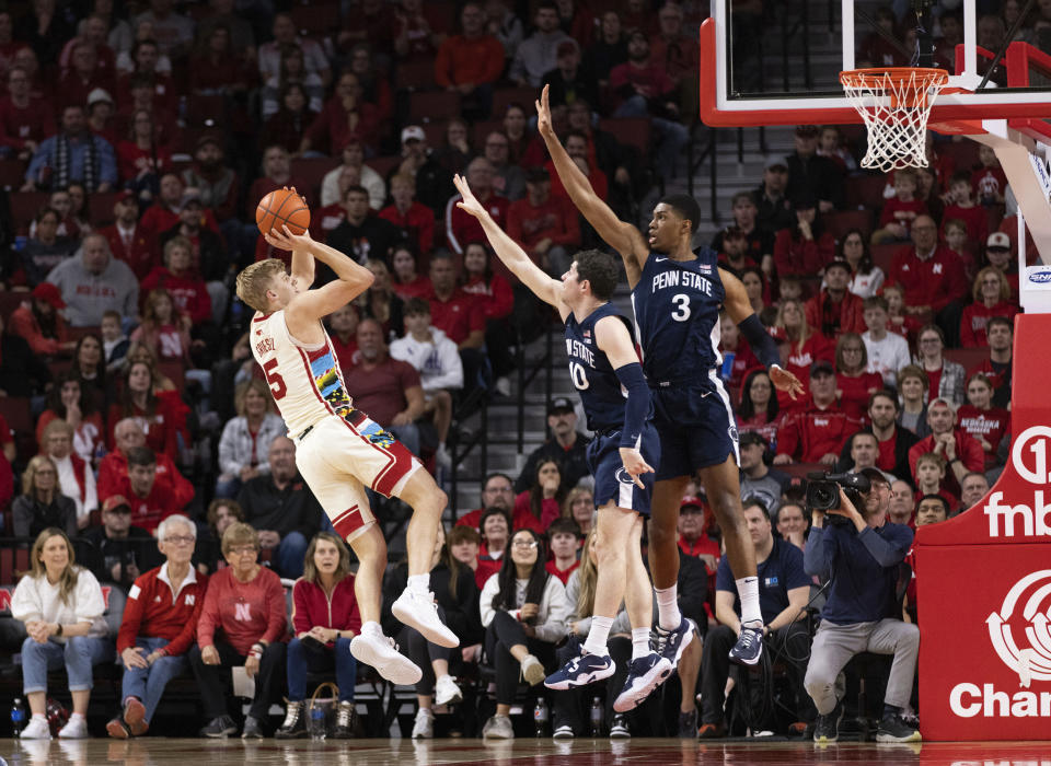 Nebraska's Sam Griesel (5) shoots against Penn State's Andrew Funk (10) and Kebba Njie (3) during the second half of an NCAA college basketball game Sunday, Feb. 5, 2023, in Lincoln, Neb. (AP Photo/Rebecca S. Gratz)