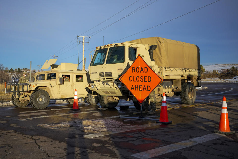 Members of the Colorado National Guard man a road block near the suspected origin of the Marshall wildfire Monday, Jan. 3, 2022, in Boulder, Colo. (AP Photo/Jack Dempsey)