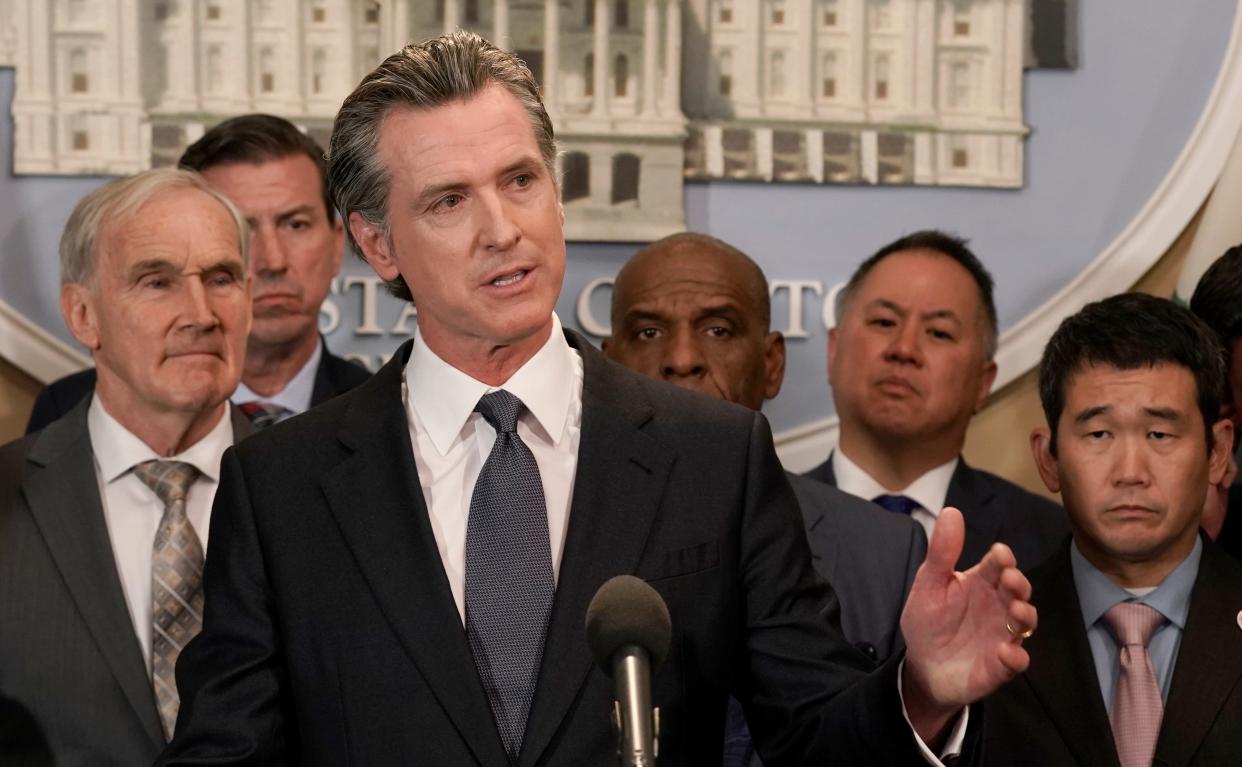 California Gov. Gavin Newsom discusses the recent mass shooting in Texas, during a news conference in Sacramento, Calif., Wednesday, May 25, 2022. Newsom signed a bill by Assemblyman Phil Ting, D-San Francisco, second from right, Tuesday, June 12, 2022, that creates a good conduct code for gun makers and dealers, and allows anyone who suffers harm from violations to sue. (AP Photo/Rich Pedroncelli File)