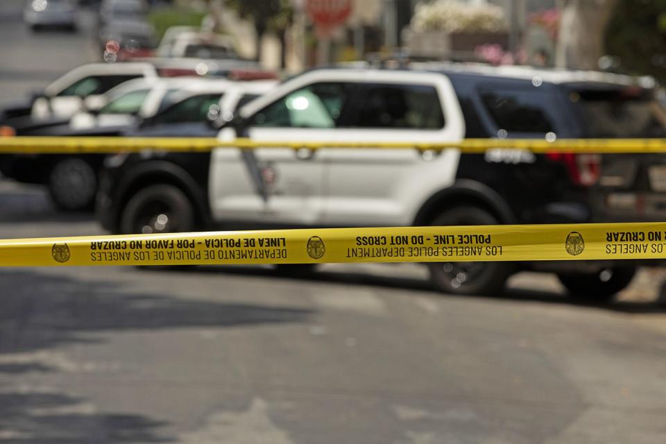 File: Getty police tape and police vehicles -- stock image