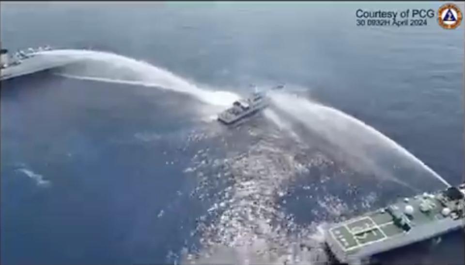 A screen grab taken from a video provided by the Philippine Coast Guard showing Chinese Coast Guard ships firing water cannons against Philippines vessels near Scarborough Shoal, South China Sea, on April 30, 2024.