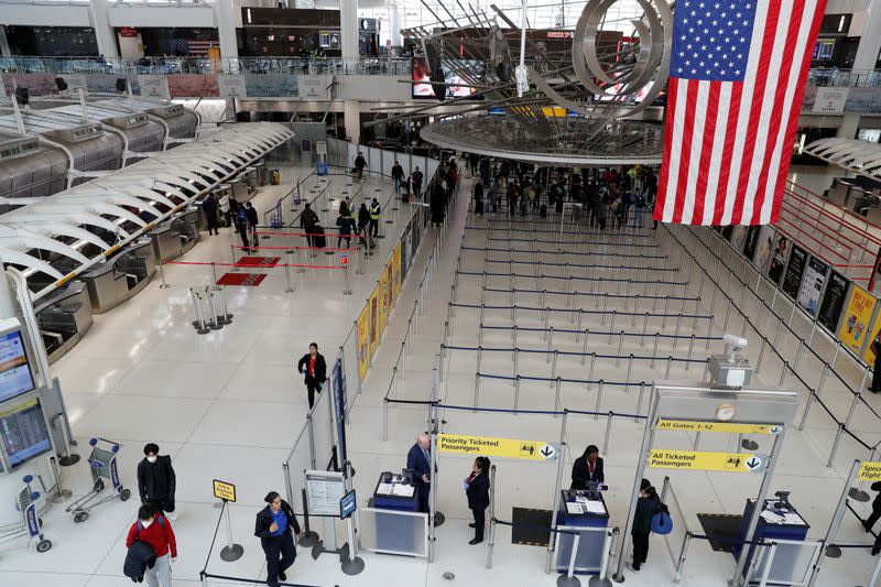 Passengers walk through Terminal 1, after further cases of coronavirus were confirmed in New York, at JFK International Airport in New York