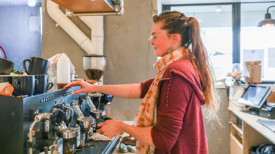 Casual female barista in cafe