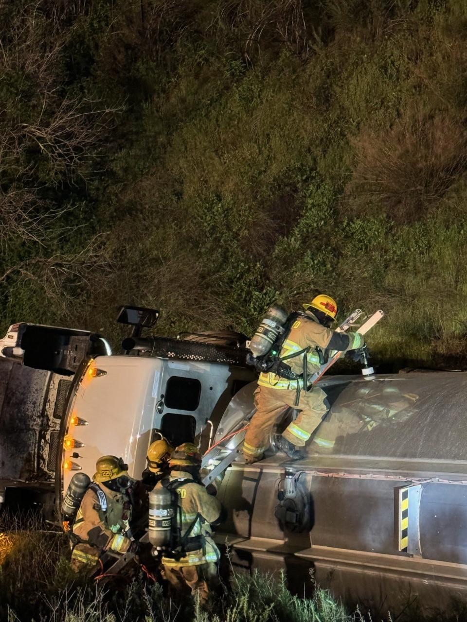 Firefighters work at the scene of a fuel truck crash along the 15 Freeway in the Cajon Pass on Tuesday, April 2, 2024.