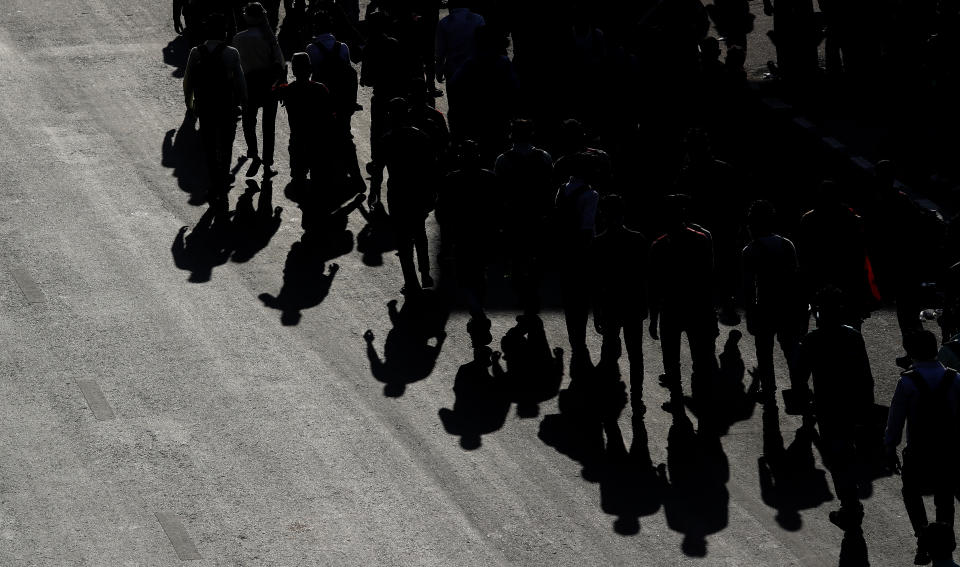 Migrant daily wage laborers make the journey to their respective villages on foot following a lockdown amid concern over spread of coronavirus in New Delhi, India, Friday, March 27, 2020. (AP Photo/Manish Swarup)