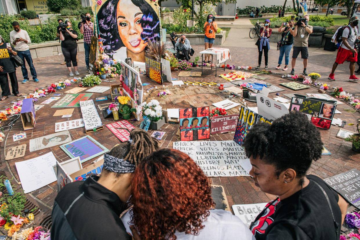 Tamika Palmer, mother of Breonna Taylor, center, is comforted as she looks over a memorial dedicated to her daughter on September 15, 2020 in Louisville, Kentucky.