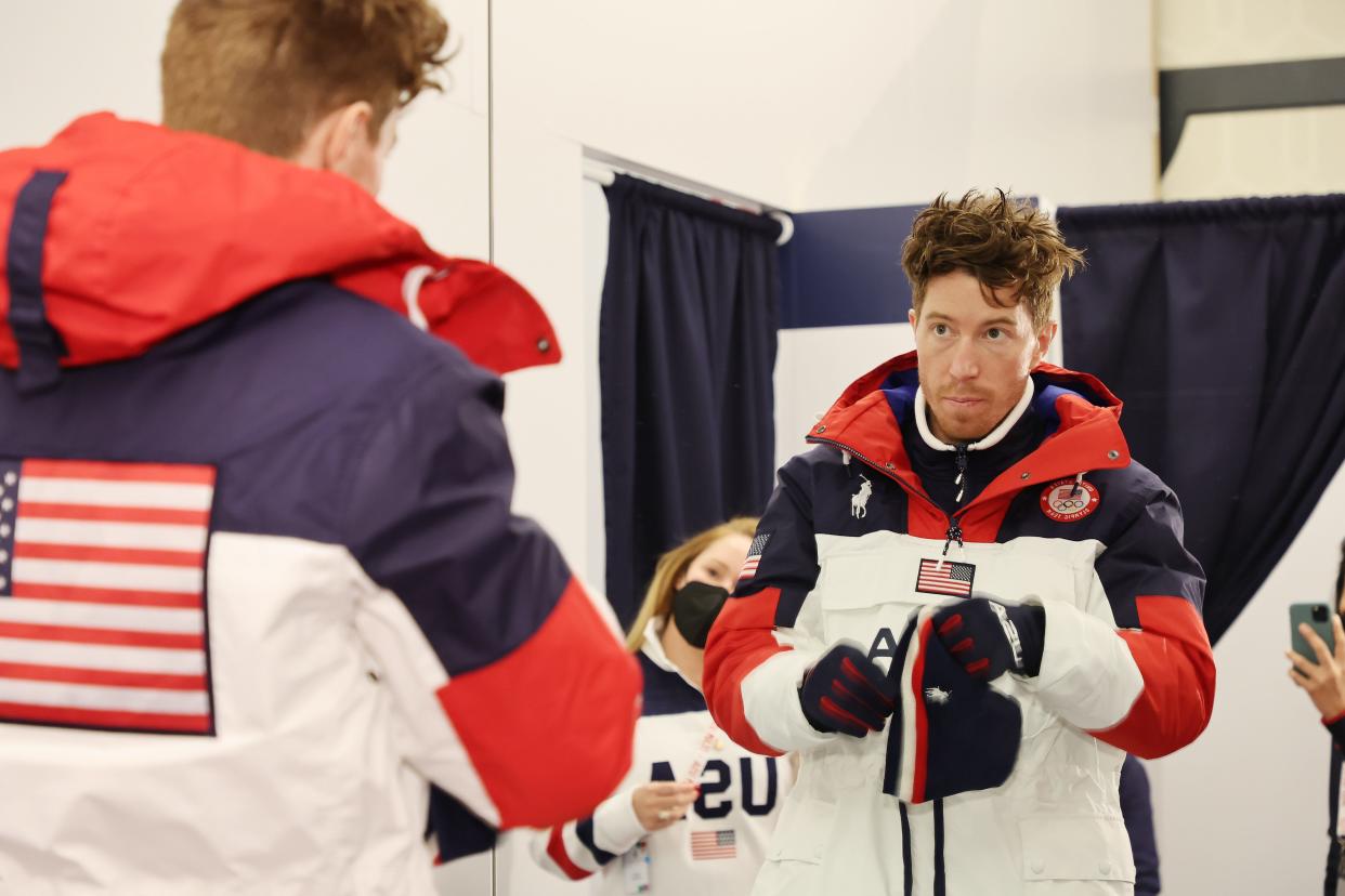 Shaun White looking in the mirror in snow jacket
