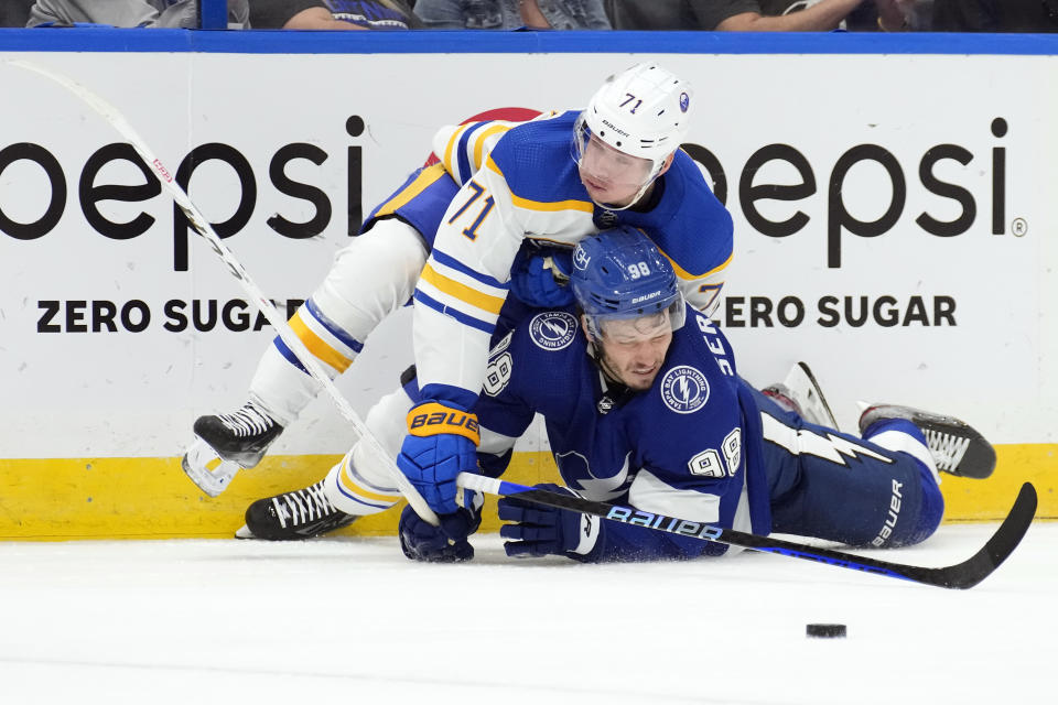 Buffalo Sabres left wing Victor Olofsson (71) takes down Tampa Bay Lightning defenseman Mikhail Sergachev (98) during the third period of an NHL hockey game Saturday, Nov. 5, 2022, in Tampa, Fla. (AP Photo/Chris O'Meara)