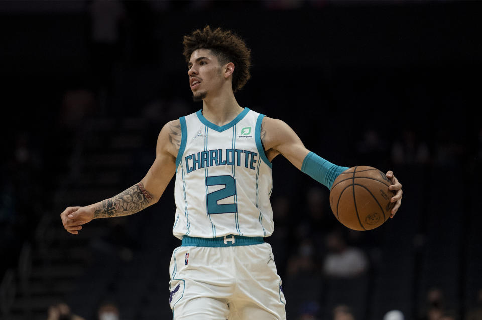 Charlotte Hornets guard LaMelo Ball (2) dribbles the ball during the first half of the team's NBA preseason basketball game against Dallas Mavericks, Wednesday, Oct. 13, 2021, in Charlotte, N.C. (AP Photo/Matt Kelley)