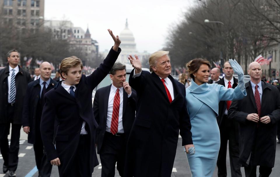 President Donald Trump waves to supporters as he walks the parade route with First Lady Melania and son Barron after being sworn in at the 58th Presidential Inauguration Jan. 20, 2017, in Washington, D.C. 