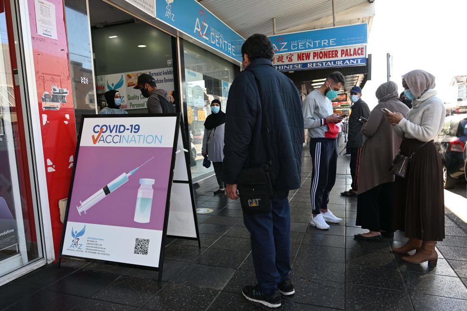 Residents queue up outside a pharmacy for a Covid-19 vaccination in western Sydney (AFP via Getty Images)