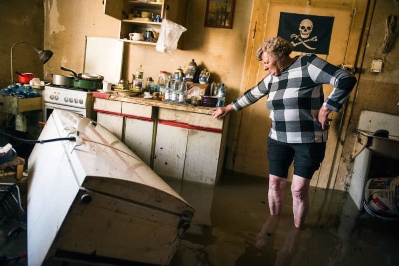 A woman stands in a flooded apartment in the southern Polish town of Lewin Brzeski. Attila Husejnow/SOPA Images via ZUMA Press Wire/dpa