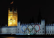 LONDON, ENGLAND - JULY 27: The Olympic rings are projected onto the House of Parliament during a light show to mark the start of the 2012 Olympic Games on July 27, 2012 in London, England. (Photo by Harry How/Getty Images)