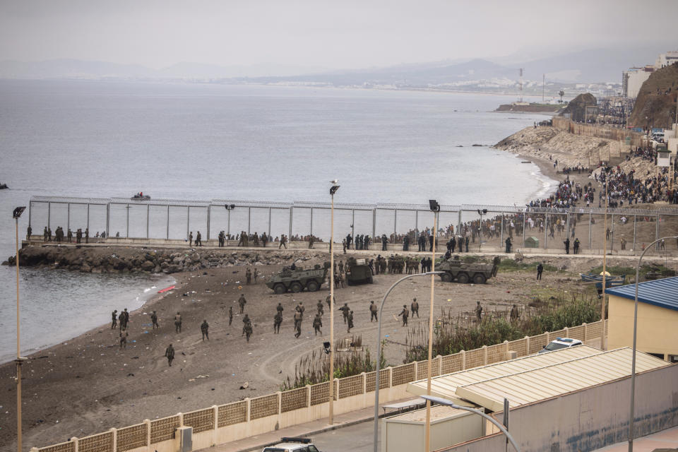 Spanish Army take positions next to the border of Morocco and Spain, at the Spanish enclave of Ceuta, on Tuesday, May 18, 2021. Ceuta, a Spanish city of 85,000 in northern Africa, faces a humanitarian crisis after thousands of Moroccans took advantage of relaxed border control in their country to swim or paddle in inflatable boats into European soil. Around 6,000 people had crossed by Tuesday morning since the first arrivals began in the early hours of Monday, including 1,500 who are presumed to be teenagers. (AP Photo/Javier Fergo)