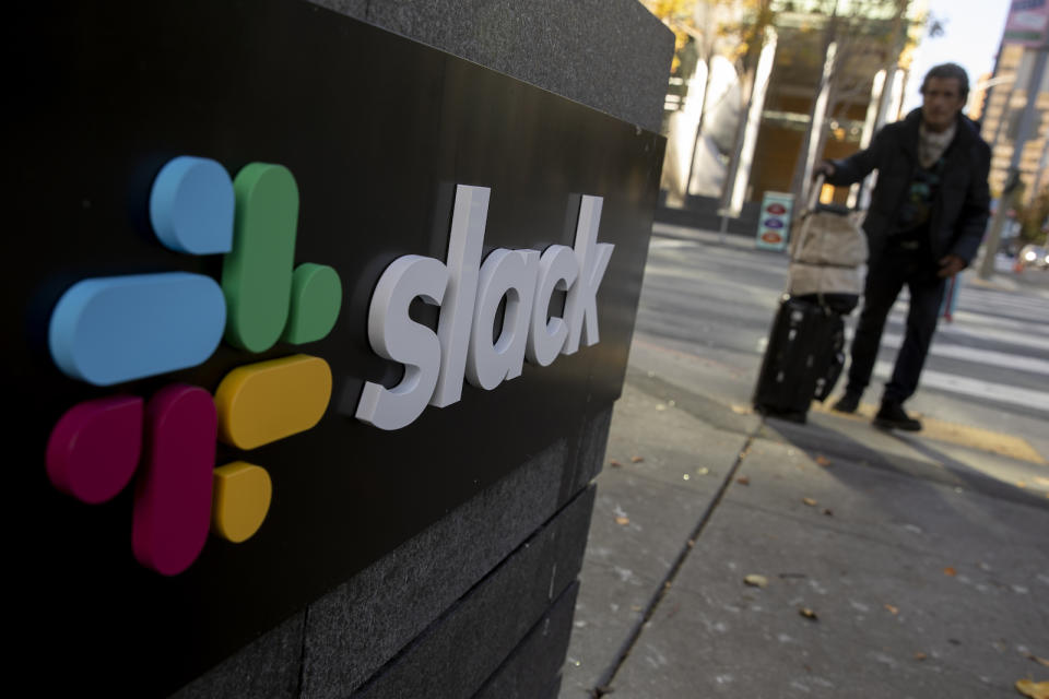 SAN FRANCISCO, CA - DECEMBER 01: A pedestrian walks past a Slack logo outside its headquarters on December 1, 2020 in San Francisco, California. Cloud-based enterprise software company Salesforce announced on Tuesday that it will purchase the popular workplace-chat app for $27.7 billion. (Photo by Stephen Lam/Getty Images)