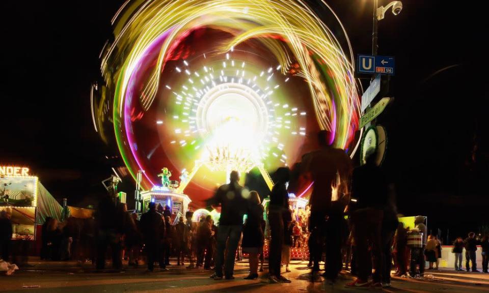 People are drawn to a luminous merry-go-round at the Oktoberfest in Munich, Germany. The fairgrounds come alive in the evenings with folk and pop music performances and, of course, more beer.