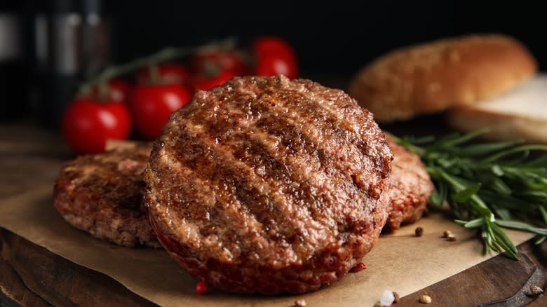 hamburger patties on wooden table