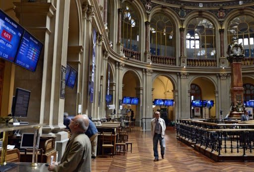 A man looks at the IBEX-35 index at the Bolsa de Madrid. World stocks fell sharply, the euro hit a 12-year low versus the yen and Spanish borrowing costs struck record highs Monday on speculation Spain could soon require a full state bailout, traders said