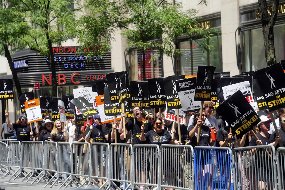 CAPTION CORRECTION: CORRECTS DATE: Writers and actors walk the picket line during a strike, Friday, July 14, 2023, at NBC Universal Studios in New York. The picketing comes a day after the main actors’ union voted to join screenwriters in a double-barreled strike for the first time in more than six decades. The dispute immediately shut down production across the entertainment industry after talks for a new contract with studios and streaming services broke down. (AP Photo/Bebeto Matthews)