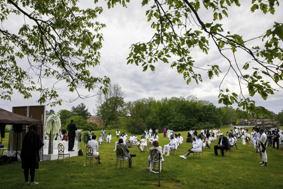 Mourners attend a socially distanced outdoor memorial service for Joanne Paylor, 62, of Washington, during her funeral at Cedar Hill Cemetery, Suitland-Silver Hill, Md., Sunday, May 3, 2020. Despite not having died from coronavirus, almost every aspect of Paylor's funeral has been impacted by the pandemic. (AP Photo/Jacquelyn Martin)