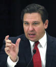 Florida Gov. Ron DeSantis answers a question during a roundtable meeting with transportation industry leaders at the Hilton Orlando-Bonnet Creek Resort in Orlando, Fla., Friday, Aug. 7, 2020. DeSantis addressed coronavirus and state transportation construction concerns. (Joe Burbank/Orlando Sentinel via AP)