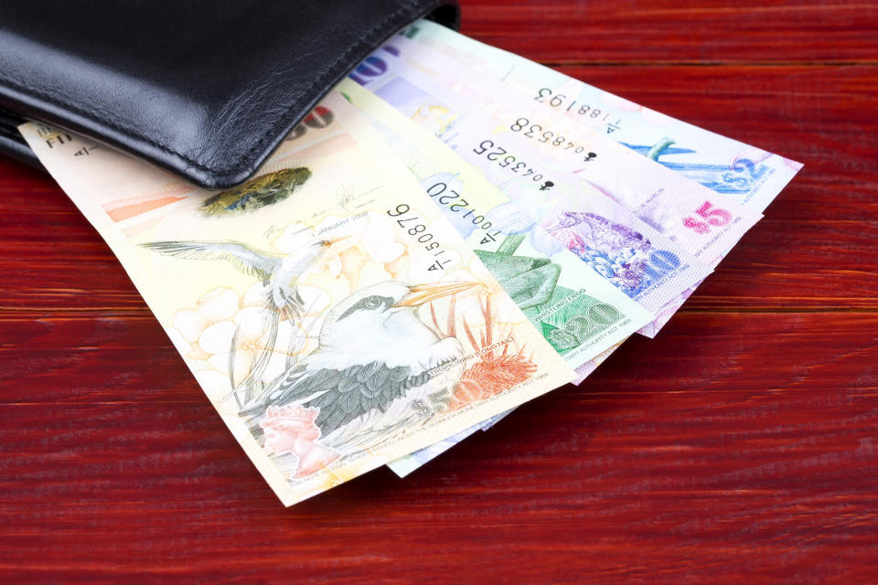 Bermudian Dollar in the black wallet on a wooden background