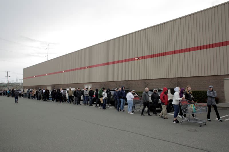 Shoppers line up before opening at a Costco store, following reports of coronavirus disease (COVID-19) cases in the country, in Seattle