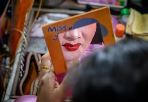 An actress applies makeup before the Sai Bo Hong Chinese opera troupe performs one its dramatic tales from an ancient world of swords and warriors