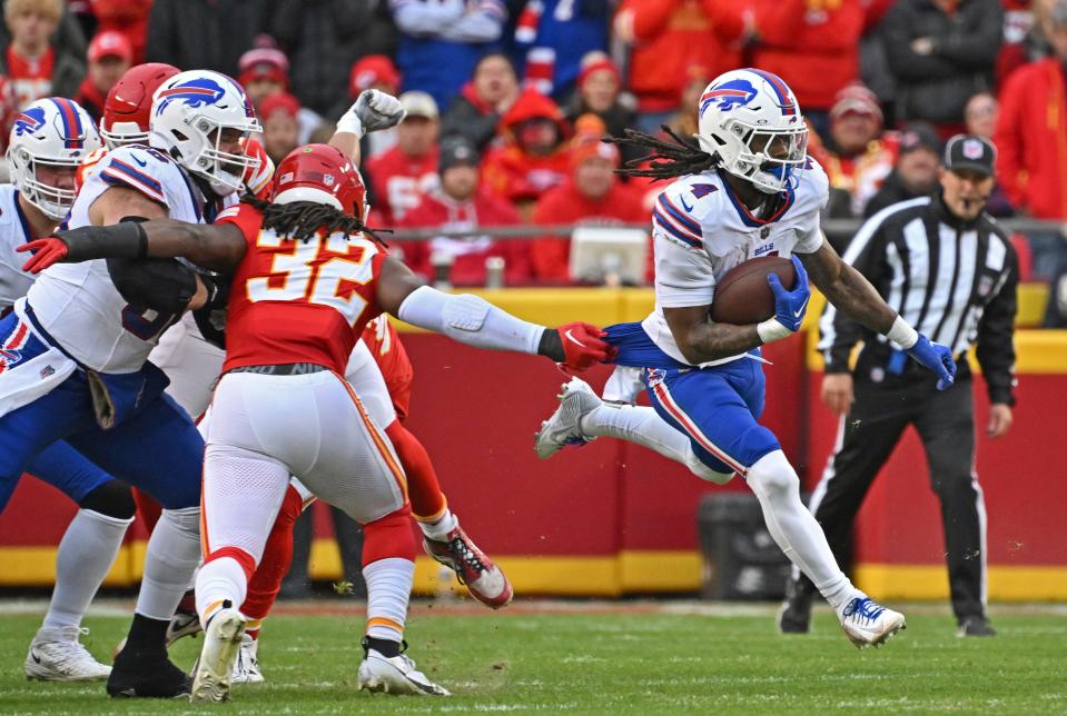 Buffalo Bills running back James Cook (4) runs up field with the ball past Kansas City Chiefs linebacker Nick Bolton (32)during an NFL football game Sunday, Dec. 10, 2023, in Kansas City, Mo. (AP Photo/Peter Aiken)