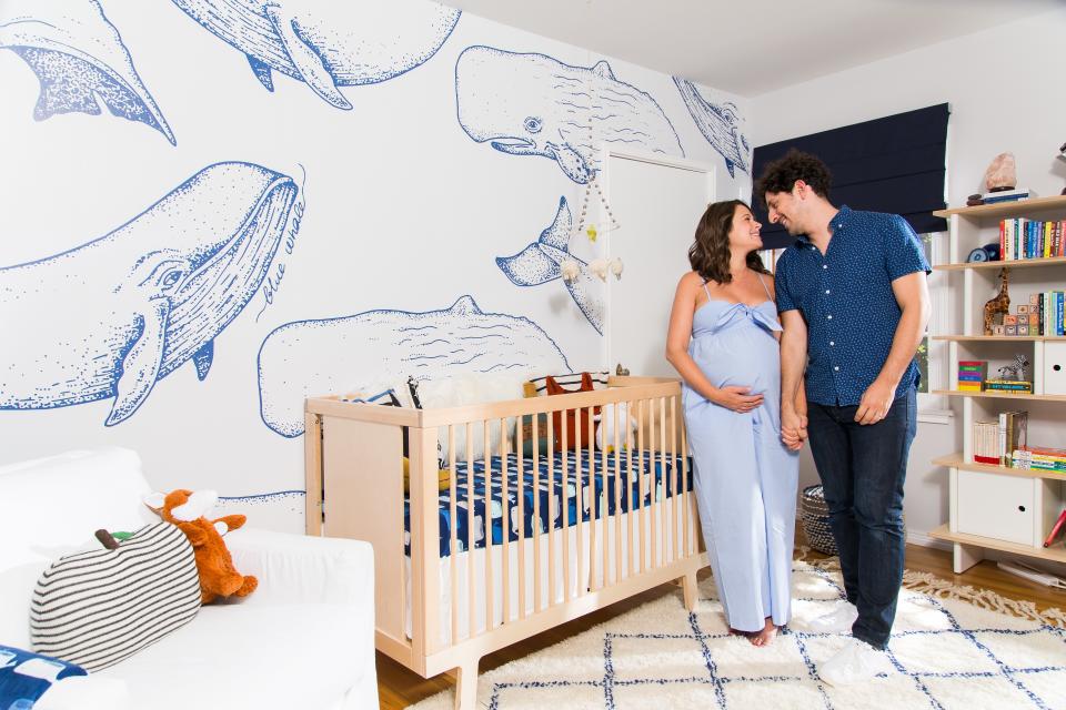 The blue and white whale wallpaper is from adhesive-backed wallpaper collection WallsNeedLove.com, and was only put on one wall so as not to overwhelm the nursery.