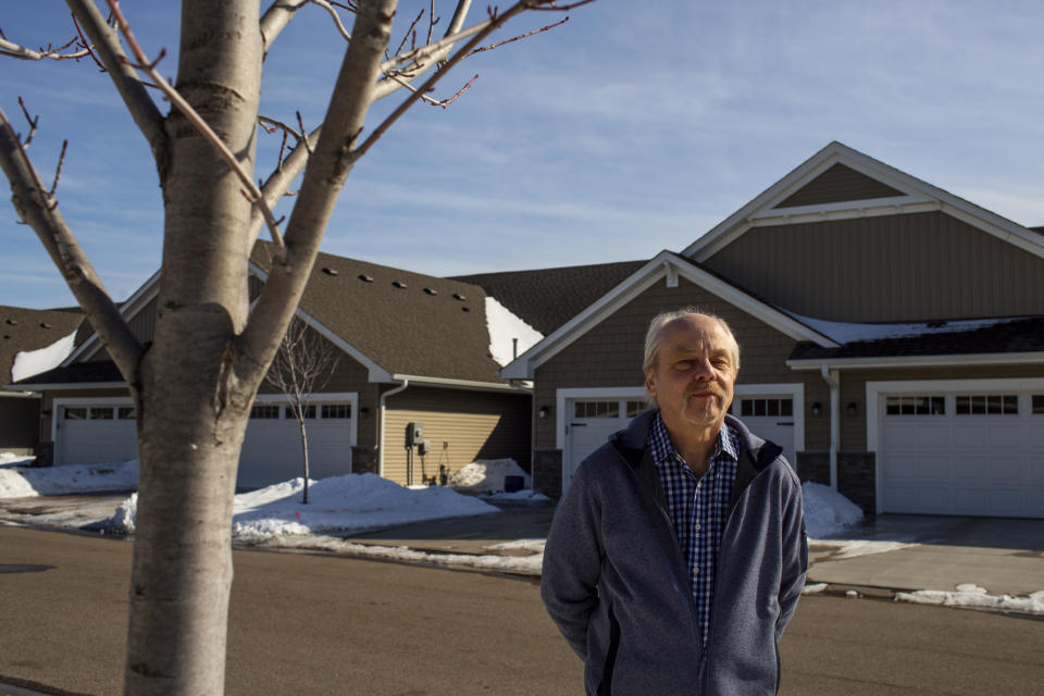 Jeffrey Carlson stands for a portrait outside his home in Vadnais Heights, Minn., on Sunday, March 13, 2022. Carlson, a Type 1 diabetic with heart stents, contracted COVID-19 in January, but recovered quickly after being treated with Merck's molnupiravir medication. (AP Photo/Nicole Neri)