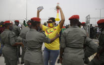 Gendarmerie search Cameroon soccer fans outside the stadium before the African Cup of Nations 2022 quarterfinal match between Gambia and Cameroon at Japoma Stadium, Douala, Cameroon, Saturday, Jan. 29, 2022. (AP Photo/Sunday Alamba)