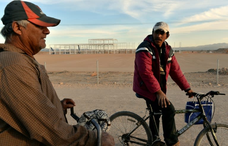 Security guards ride their bicycles around unfinished buldings on the site of a called off Ford car factory in Villa de Reyes, near San Luis Potosi, Mexico