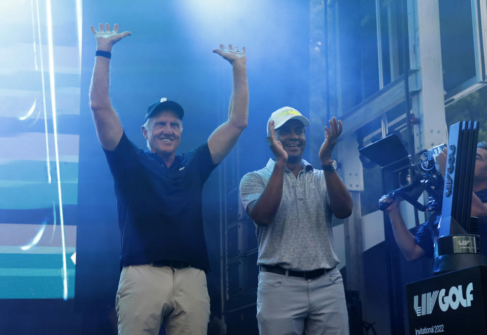LIV Golf CEO Greg Norman, left, and LIV Golf managing director Majed Al Sorour cheer from the stage before the trophy presentation at the LIV Golf Invitational-Boston tournament, Sunday, Sept. 4, 2022, in Bolton, Mass. (AP Photo/Mary Schwalm)