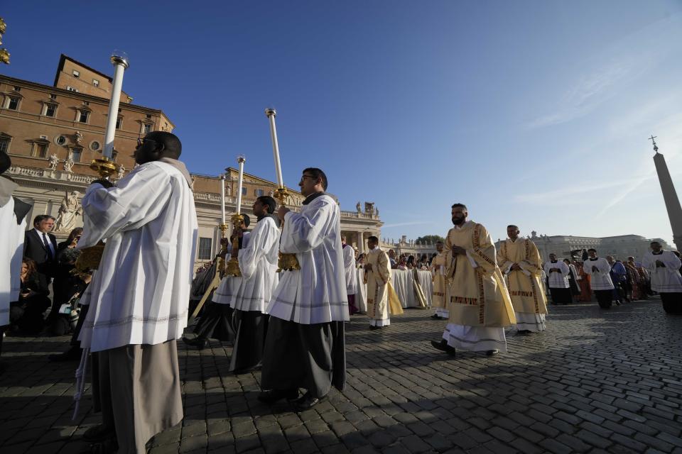 Prelates arrive for a mass presided over by Pope Francis and concelebrated by the new cardinals for the start of the XVI General Assembly of the Synod of Bishops in St. Peter's Square at The Vatican, Wednesday, Oct.4, 2023. Pope Francis is convening a global gathering of bishops and laypeople to discuss the future of the Catholic Church, including some hot-button issues that have previously been considered off the table for discussion. Key agenda items include women's role in the church, welcoming LGBTQ+ Catholics, and how bishops exercise authority. For the first time, women and laypeople can vote on specific proposals alongside bishops (AP Photo/Andrew Medichini)