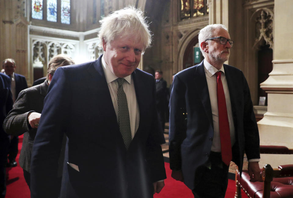 Prime Minister Boris Johnson, foreground, and Labour Party leader Jeremy Corbyn arrive for the State Opening of Parliament at the Houses of Parliament in London, Thursday, Dec. 19, 2019. Britain's Queen Elizabeth II formally opened a new session of Parliament on Thursday, with a speech giving the first concrete details of what Johnson plans to do with his commanding House of Commons majority. (Hannah McKay/Pool via AP)
