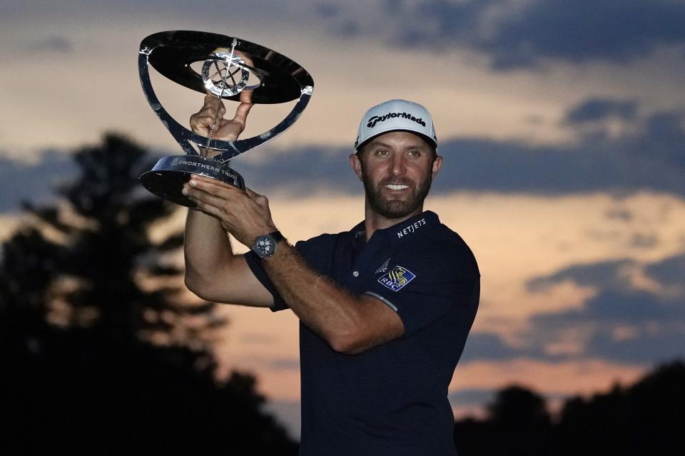 Dustin Johnson holds the trophy after winning the Northern Trust golf tournament at TPC Boston, Sunday, Aug. 23, 2020, in Norton, Mass. (AP Photo/Charles Krupa)