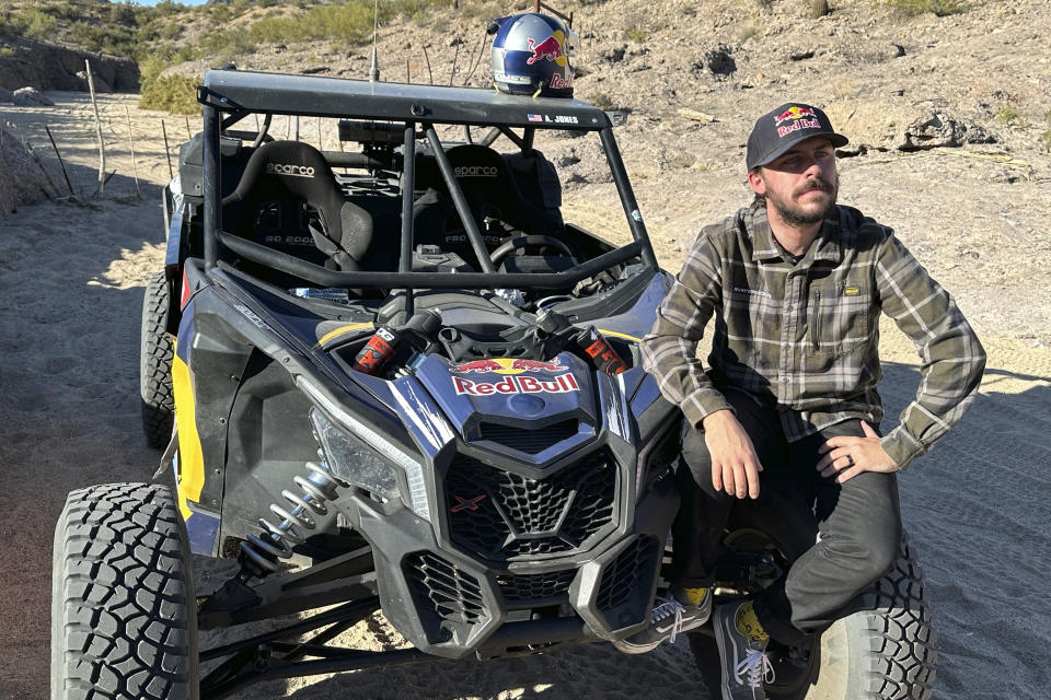 AJ Jones, the youngest driver and only American to win the Dakar Rally twice, poses on Nov. 27, 2023, in Congress, Ariz.. He also has won the Baja 1000 twice. Jones followed the footsteps of his father, Jesse, an accomplished rally car racer after playing lacrosse on scholarship at San Diego State. (AP Photo/John Marshall)